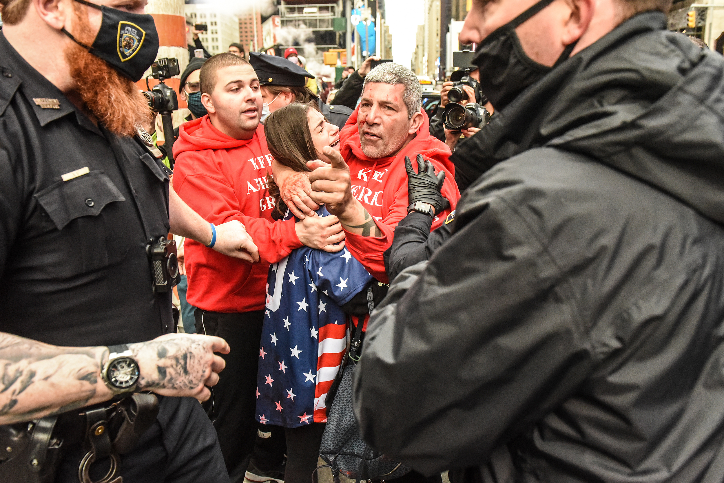 A Trump supporter points out the person he thinks attacked him and his daughter (left) during a pro-Trump rally in Times Square in New York, New York, U.S. October 25, 2020. Several counter protesters were arrested during the afternoon of clashes in Times